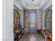 Chic foyer features wood-look floors, a modern chandelier, and stylish decor at 8713 Long Winter Ct, Las Vegas, NV 89131
