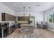 Modern kitchen with gray cabinetry, stainless steel appliances, and a brick-style island at 8713 Long Winter Ct, Las Vegas, NV 89131