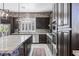 A spacious kitchen with dark wood cabinets, granite countertops and stainless steel appliances at 8713 Long Winter Ct, Las Vegas, NV 89131