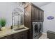 An updated laundry room featuring modern washer and dryer, sink and custom cabinetry at 8713 Long Winter Ct, Las Vegas, NV 89131