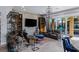 Cozy living room with sliding glass doors to the patio, built-in shelves, and tv at 8713 Long Winter Ct, Las Vegas, NV 89131