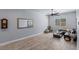 Living room with light-gray walls and wood-look tile floors, with black couch and modern decor at 8713 Long Winter Ct, Las Vegas, NV 89131