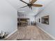 Large living area featuring wood-look tile flooring and an open layout to the kitchen at 8713 Long Winter Ct, Las Vegas, NV 89131