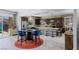 Open-concept living space featuring a modern kitchen, dining area, and patio access at 8713 Long Winter Ct, Las Vegas, NV 89131