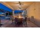 Outdoor kitchen and dining area complete with a built-in grill, bar seating, and cozy fire pit at 8713 Long Winter Ct, Las Vegas, NV 89131