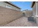 Enclosed backyard with brick pavers, privacy walls, and an AC unit at 912 Allister Fields Ln, Las Vegas, NV 89138