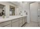 Bathroom featuring double sinks, a full vanity mirror, and gray cabinets at 912 Allister Fields Ln, Las Vegas, NV 89138