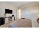 Bright bedroom with carpet, tv, sliding-door closet, and a smooth ceiling at 912 Allister Fields Ln, Las Vegas, NV 89138