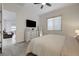 Cozy bedroom with ceiling fan, dresser with decor, and a comfortable view of the living area at 912 Allister Fields Ln, Las Vegas, NV 89138