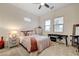 Comfortable bedroom featuring carpet, a ceiling fan, large windows and a keyboard for music at 912 Allister Fields Ln, Las Vegas, NV 89138