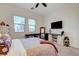 Cozy bedroom with natural light, ceiling fan, and television on sliding-door media center at 912 Allister Fields Ln, Las Vegas, NV 89138