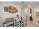 Elegant dining area with rustic table, upholstered chairs, and artistic wall decor at 912 Allister Fields Ln, Las Vegas, NV 89138