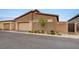 Contemporary home featuring a two-car garage with stone accents, gate, and desert landscaping at 912 Allister Fields Ln, Las Vegas, NV 89138
