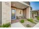 Exterior front porch view with brick floor, blue door, stone columns, and desert landscaping at 912 Allister Fields Ln, Las Vegas, NV 89138