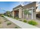 Landscaped front yard with walkway leading to a covered porch, desert landscaping, and modern exterior at 912 Allister Fields Ln, Las Vegas, NV 89138