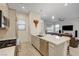 Modern kitchen with stainless steel appliances, quartz countertops, and views of the living area at 912 Allister Fields Ln, Las Vegas, NV 89138