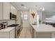 Well-lit kitchen featuring stainless steel appliances, quartz countertops, and a modern aesthetic at 912 Allister Fields Ln, Las Vegas, NV 89138