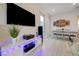 Modern living room featuring entertainment center with large TV and stylish dining area at 912 Allister Fields Ln, Las Vegas, NV 89138