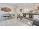 Open-concept living area with dining table, leather sofa, and stylish decor for a comfortable living space at 912 Allister Fields Ln, Las Vegas, NV 89138