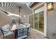 Charming outdoor patio with modern furniture and a striped umbrella for shade at 912 Allister Fields Ln, Las Vegas, NV 89138