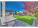 Manicured backyard featuring a pergola, brick patio, privacy wall, and lush landscaping at 9628 Matanzas Creek Ct, Las Vegas, NV 89139