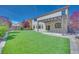 Large backyard showcasing a pergola, well-maintained lawn, and covered patio area at 9628 Matanzas Creek Ct, Las Vegas, NV 89139