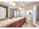 Bathroom featuring double sinks, a large mirror, and a shower/tub combo at 9628 Matanzas Creek Ct, Las Vegas, NV 89139