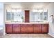 Bathroom with a double sink vanity, cabinet storage, and modern fixtures at 9628 Matanzas Creek Ct, Las Vegas, NV 89139