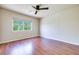 Bright bedroom features wood floors, a ceiling fan, and a window offering natural light at 9628 Matanzas Creek Ct, Las Vegas, NV 89139