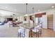 Open-concept kitchen with a large island, seating, and seamless flow into dining and living areas at 9628 Matanzas Creek Ct, Las Vegas, NV 89139