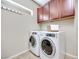 Modern laundry machines in bright area, with upper storage at 9628 Matanzas Creek Ct, Las Vegas, NV 89139