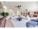 Expansive living area with tile floors, tray ceilings, recessed lighting, and open layout to kitchen/dining area at 9628 Matanzas Creek Ct, Las Vegas, NV 89139