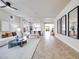 Bright, open-concept living room with tile floors, neutral decor, and a seamless flow to the dining area at 9628 Matanzas Creek Ct, Las Vegas, NV 89139