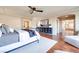 Bright main bedroom with hardwood floors, ceiling fan and a relaxing sitting area with natural light at 9628 Matanzas Creek Ct, Las Vegas, NV 89139