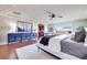 Bright main bedroom with hardwood floors, ceiling fan and a relaxing sitting area with natural light at 9628 Matanzas Creek Ct, Las Vegas, NV 89139