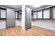 Spacious walk-in closet featuring custom built-in storage units and laminate wood flooring at 9628 Matanzas Creek Ct, Las Vegas, NV 89139