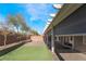 Large covered patio and artificial grass offer low maintenance outdoor enjoyment at 9883 Russian Hill St, Las Vegas, NV 89141