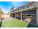 Spacious backyard with covered patio and turf, ideal for outdoor living and entertaining at 9883 Russian Hill St, Las Vegas, NV 89141