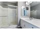 Bright bathroom features a glass enclosed shower and modern vanity with a large mirror at 9883 Russian Hill St, Las Vegas, NV 89141