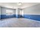 Bright, carpeted bedroom with two-tone walls and natural light from a window at 9883 Russian Hill St, Las Vegas, NV 89141