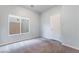 Carpeted bedroom with a window and a white door at 9883 Russian Hill St, Las Vegas, NV 89141