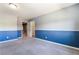 Carpeted bedroom with two-tone walls and an open doorway leading to other spaces at 9883 Russian Hill St, Las Vegas, NV 89141