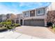 Beautiful home with a three-car garage, brick driveway, and manicured landscaping at 9883 Russian Hill St, Las Vegas, NV 89141