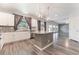 Modern kitchen with granite counters, stainless appliances, and an island with views of the living area at 9883 Russian Hill St, Las Vegas, NV 89141