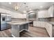 Beautiful kitchen featuring granite countertops, stainless steel appliances, white cabinets and a central island at 9883 Russian Hill St, Las Vegas, NV 89141