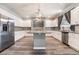 Well-lit kitchen with stainless steel appliances, granite countertops, white cabinets, and a kitchen island at 9883 Russian Hill St, Las Vegas, NV 89141