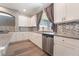 This contemporary kitchen features granite countertops, stainless steel appliances, and custom cabinetry at 9883 Russian Hill St, Las Vegas, NV 89141
