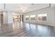 Bright, open living room featuring hardwood floors and large windows offering plenty of natural light at 9883 Russian Hill St, Las Vegas, NV 89141