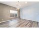 Open living area with hardwood floors, modern light fixture, and natural light at 9883 Russian Hill St, Las Vegas, NV 89141