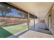 Covered patio overlooking a turf yard and block wall, perfect for outdoor entertaining at 9883 Russian Hill St, Las Vegas, NV 89141